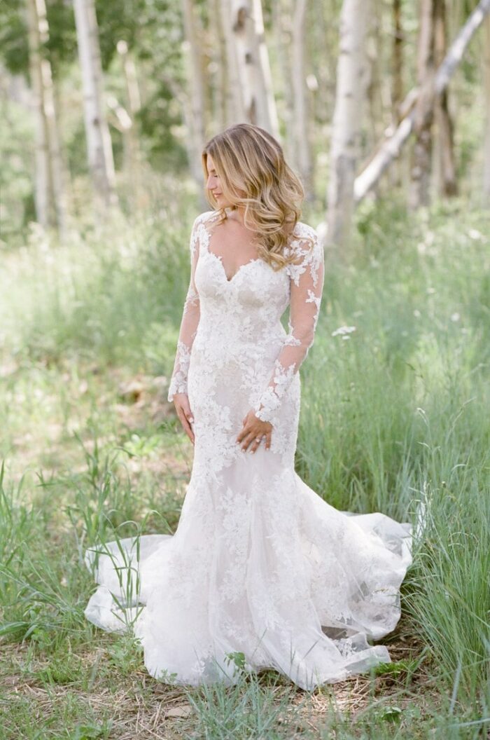 Bride wearing custom lace gown by Monique Lhuillier