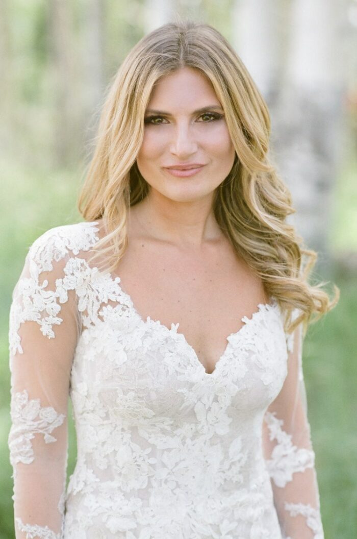 Portrait of bride wearing lace fabric gown with sleeveless bodice