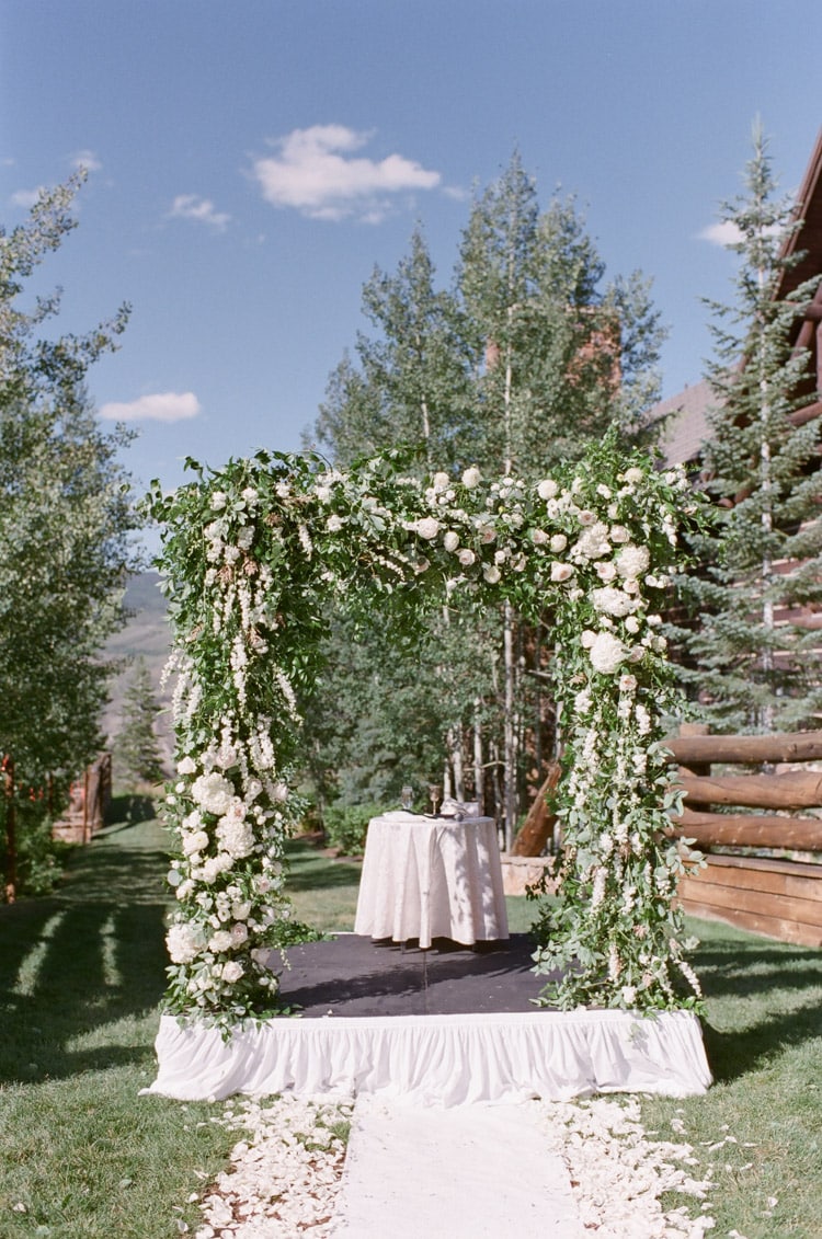 Wedding Ceremony beautiful chuppah with lots of greenery and flowers