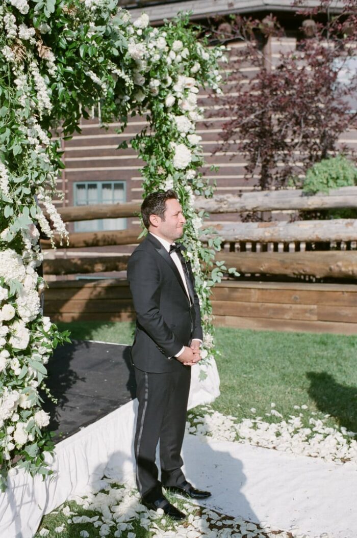 Groom waiting on his bride at beginning of ceremony