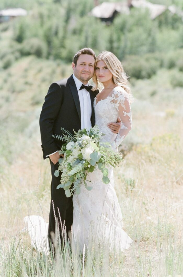 Portrait session of wedding couple in grass field in Colorado