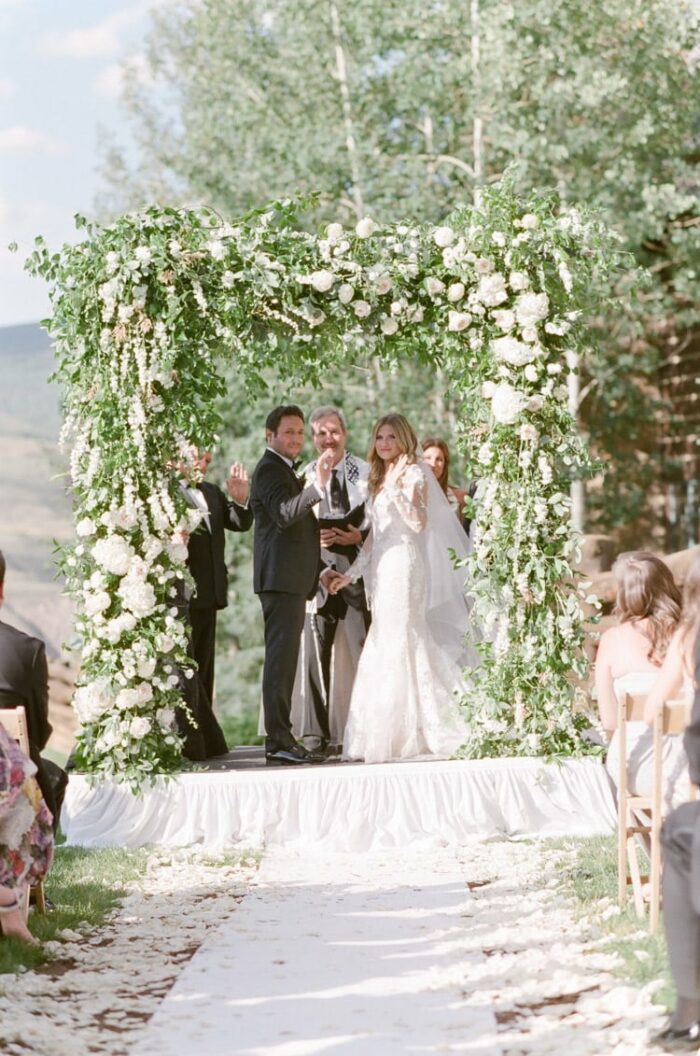 Bride and groom waving to the crowd at wedding ceremony