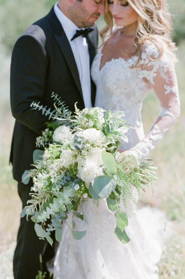 Colorado marriage session with couple wearing black tuxedo and white wedding gown embracing each other
