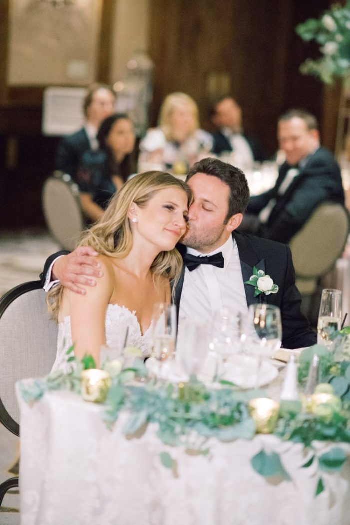 Husband kissing his wife at wedding reception