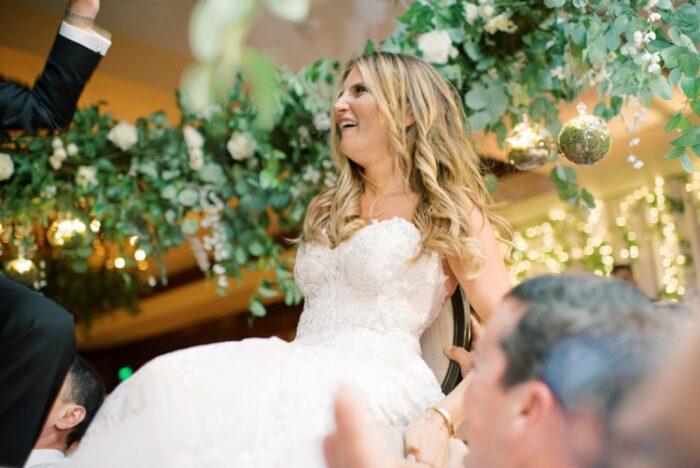 Bride lifted up in chair