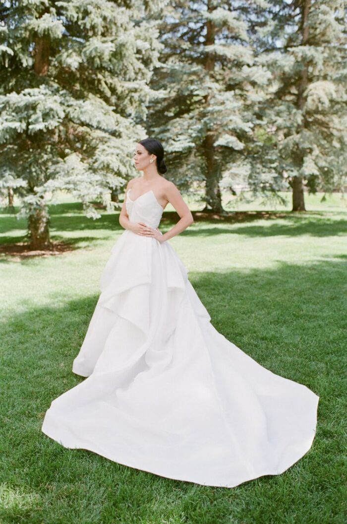 Side view of bride posing on grass