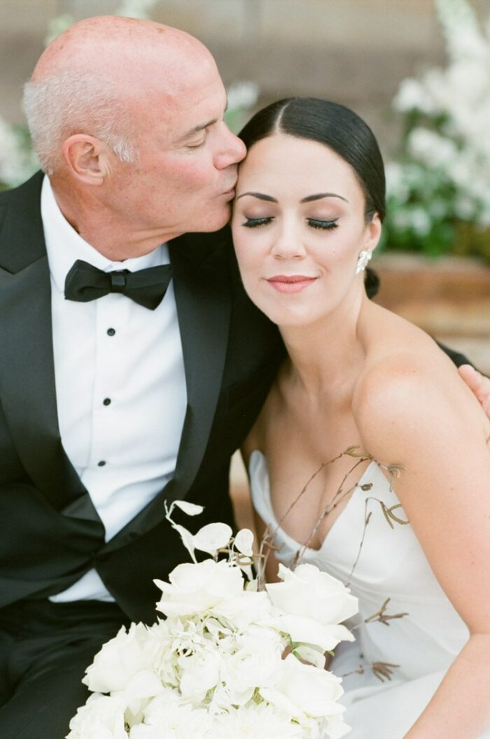 Woman to be married, kissed by father on head