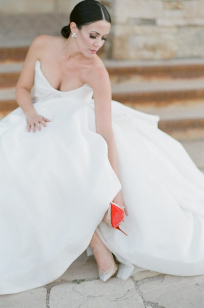 Bride looking at her Louboutin shoes