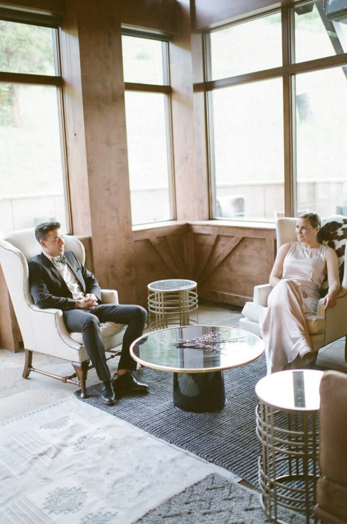People relaxing at wedding reception sitting in chairs