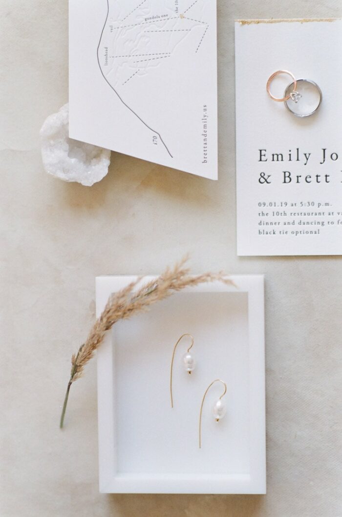 Closeup of wedding earrings and bands