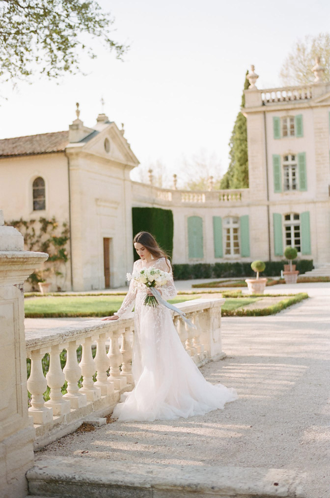 Wedding session of bride posing in front of French building