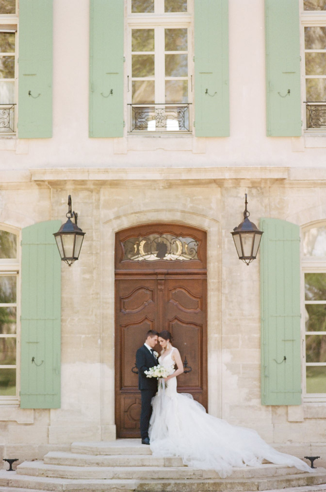 Wedding couple in front of large wooden door