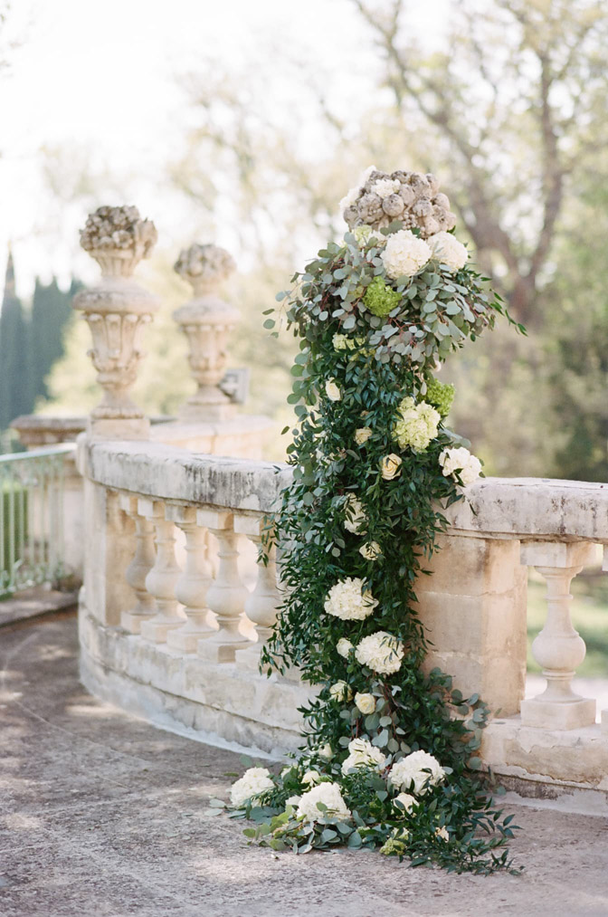 Greenery and white floral decorations on railing