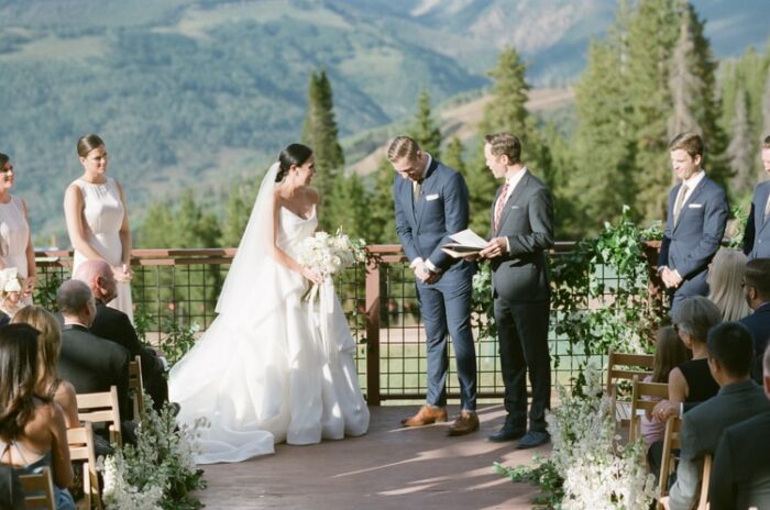 Bride and groom laughing during their wedding ceremony in Vail