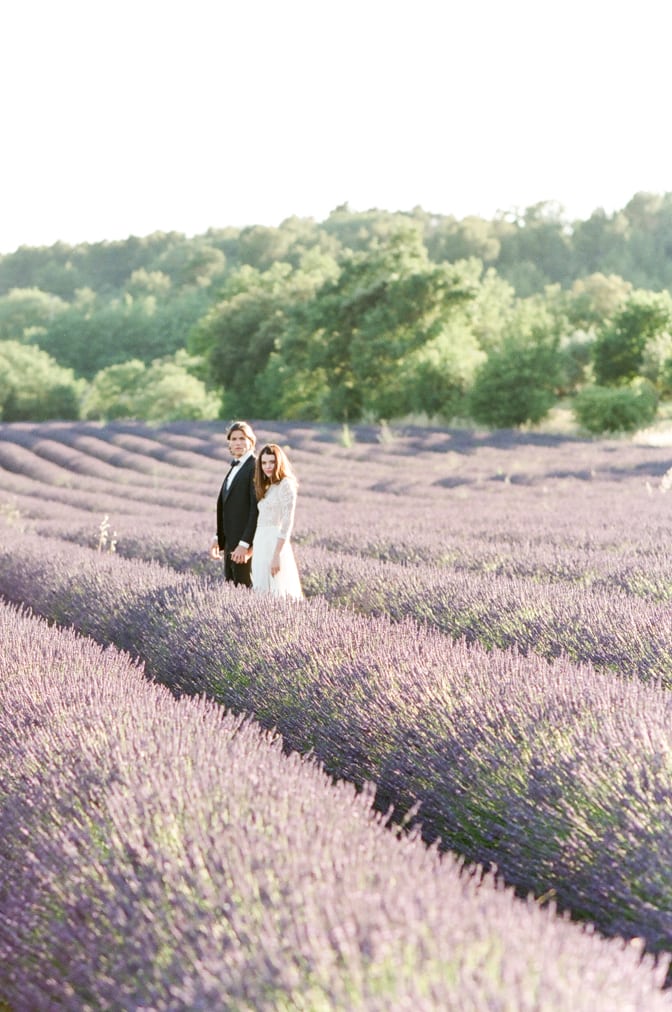 Bride and Groom holding hands in the lavender fields of the Luberon in Provence in France