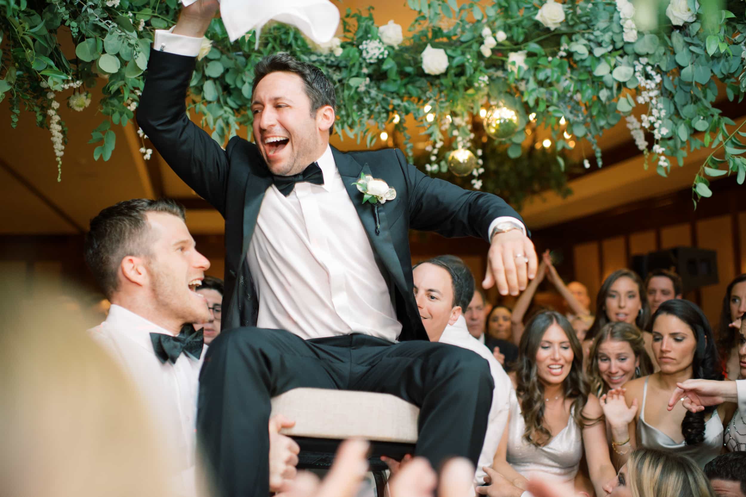 Groom is cheering during his wedding reception hora at the Ritz Carlton in Bachelor Gulch in Colorado