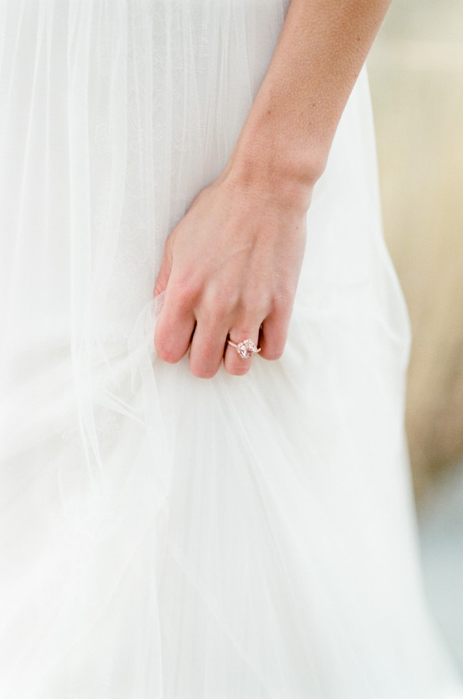 Closeup of a hand with a luxury designer engagement ring by Brian Gavin