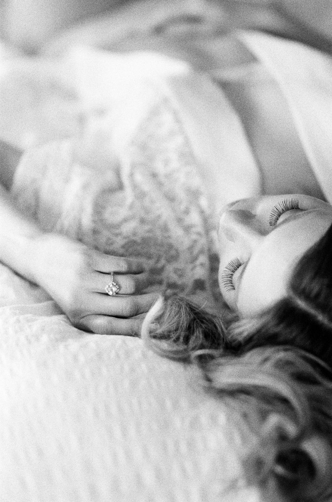 Bride at her boudoir session wearing a luxury designer engagement ring by Brian Gavin