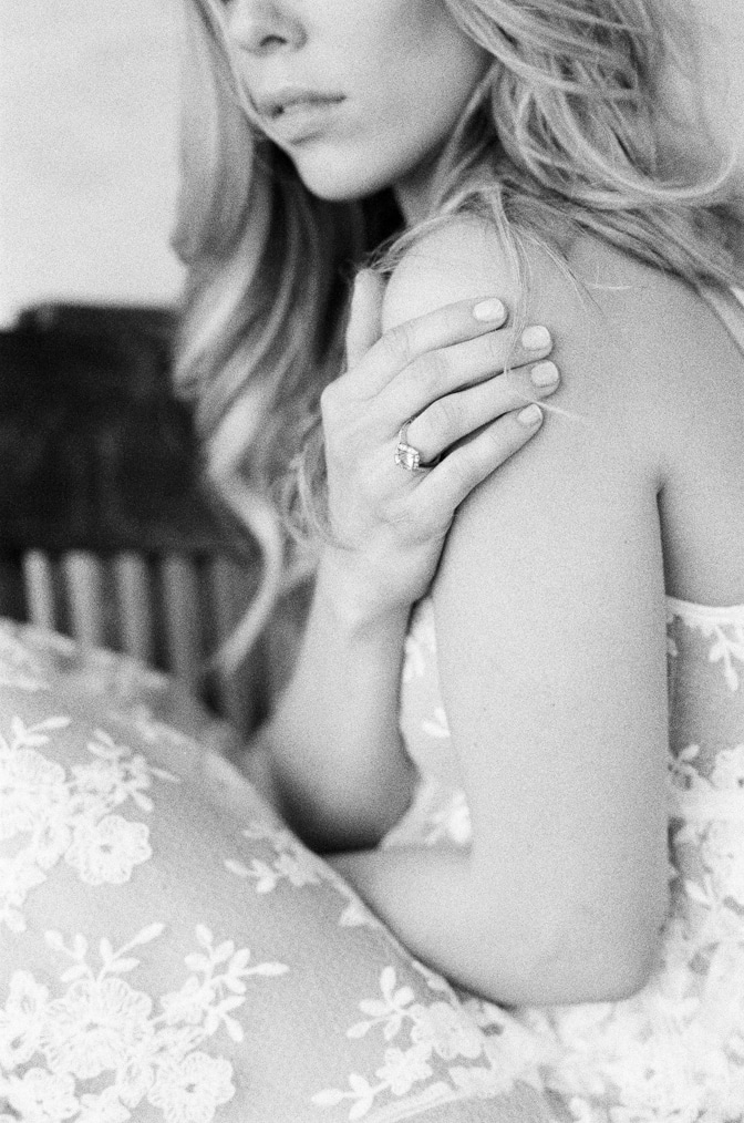 Closeup of a bride during her boudoir session with her luxury designer engagement ring by Brian Gavin