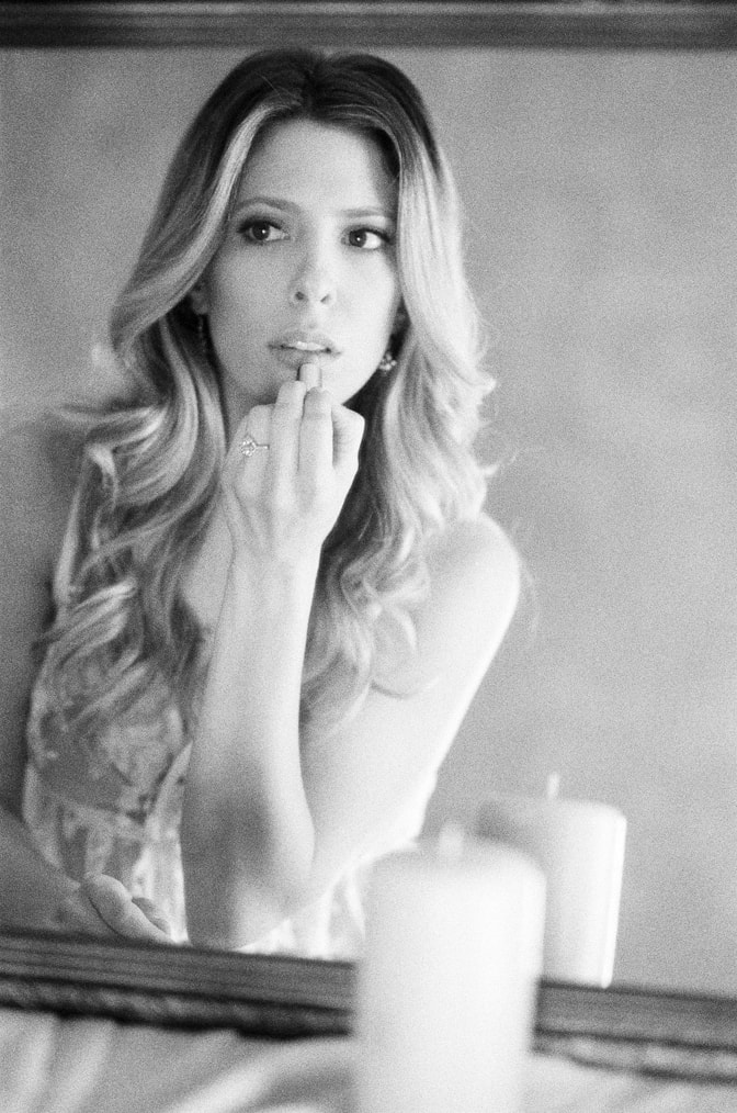 Bride during her boudoir session showcasing her luxury designer engagement ring by Brian Gavin