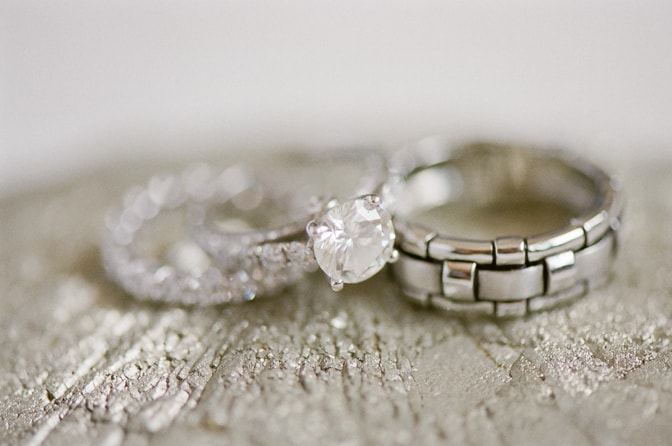 Closeup of luxury designer engagement ring and bands by Tiffany & Co