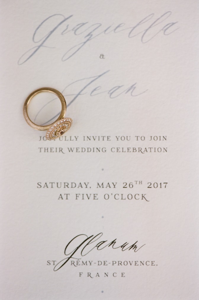 Luxury designer engagement ring by Michaela Roemer placed on top of an invitation suite