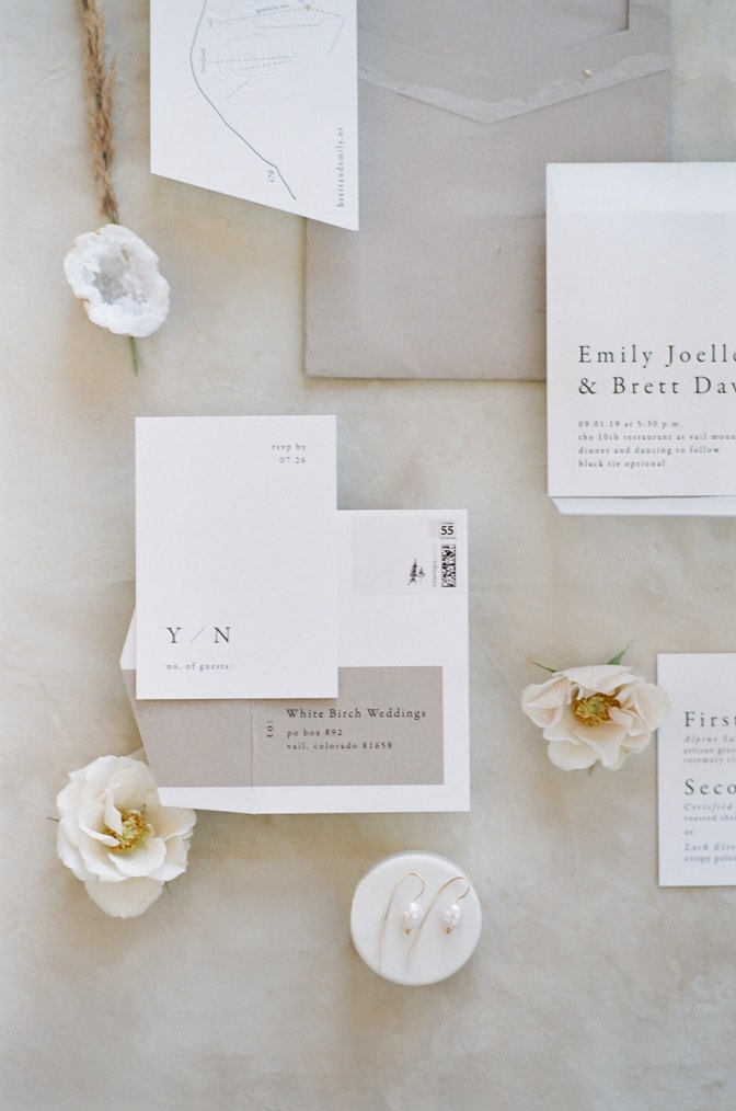 Closeup of modern luxury letterpress wedding invitation in white and beige