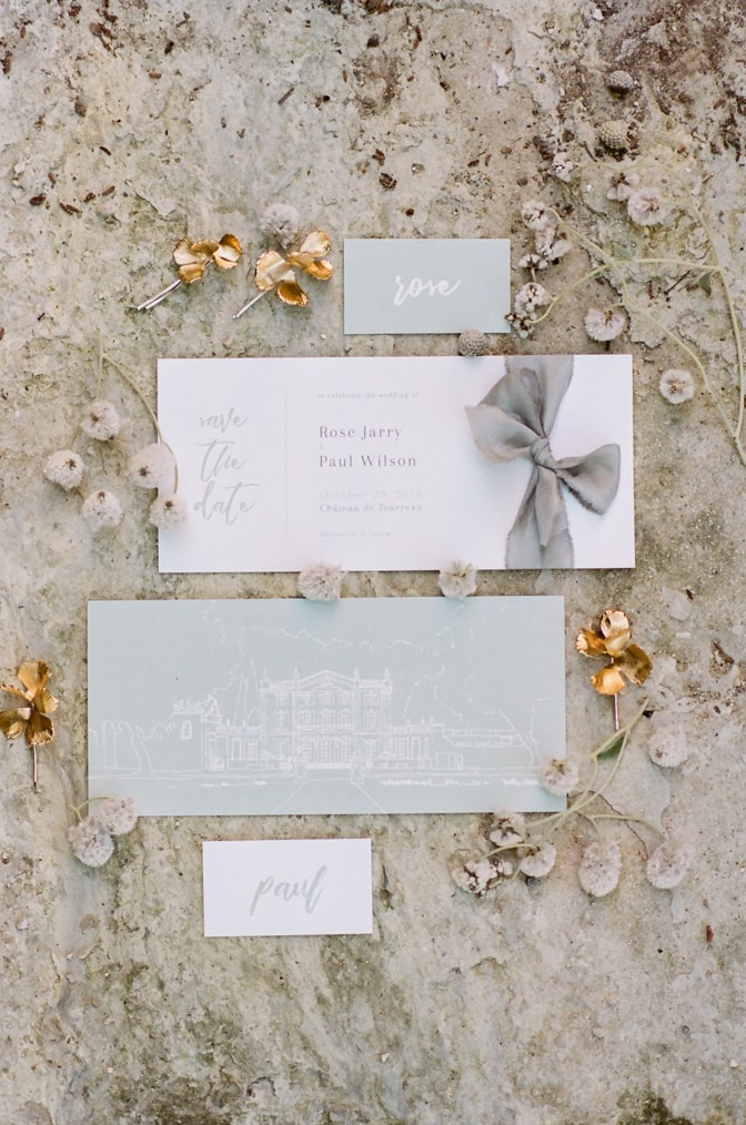 Modern luxury wedding invitation surrounded by jewelry