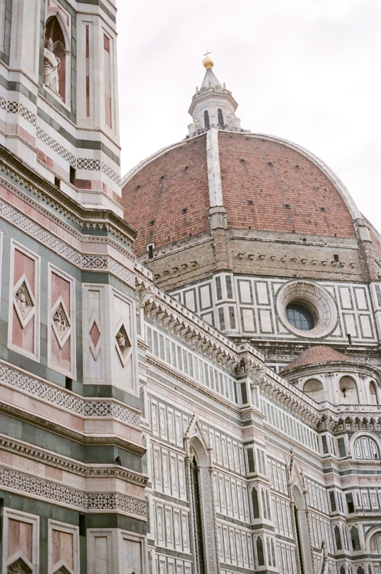 The dome of the Cathedral in Florence with its red bricks and surrounding white and green marble tiles