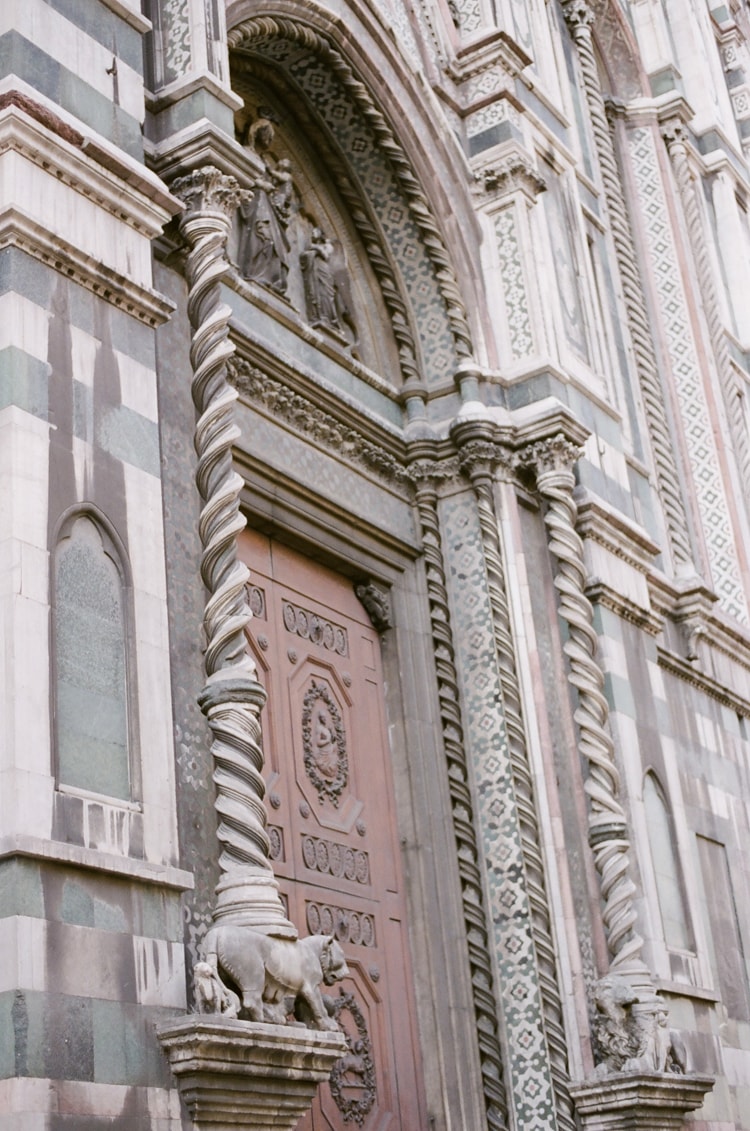 Closeup of a door of the Cathedral in Florence with its beautiful white and green marble tiles