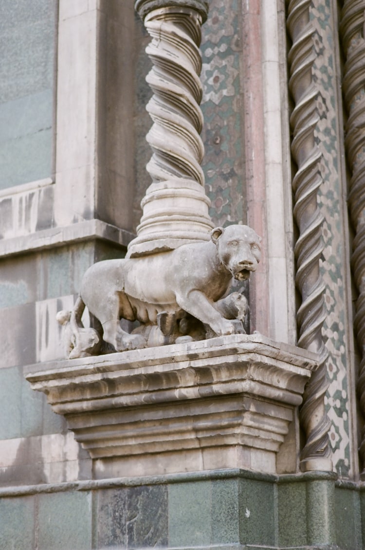 Closeup of a door from the Cathedral in Florence depicting a wolf