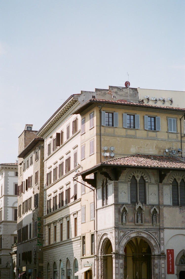 Yellow colored buildings surrounding the Cathedral in Florence Italy