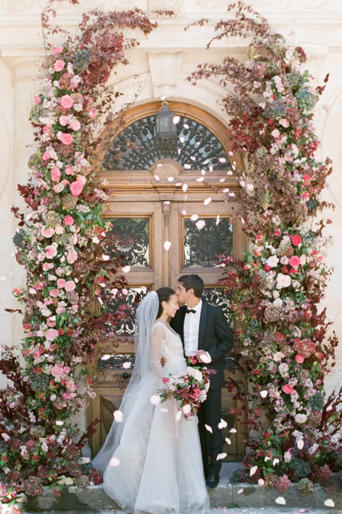 Bride and groom kissing after saying 'yes' to each other during their wedding ceremony at Chateau Martinay in Provence