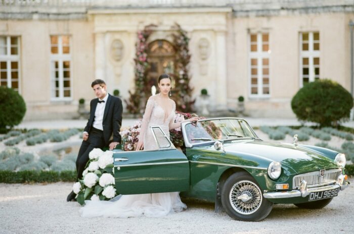 Wedding couple in front of a luxurious car at Chateau Martinay in Provence