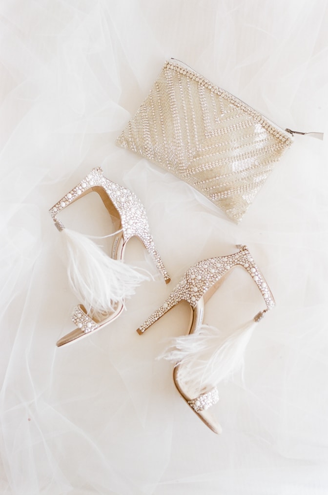 Luxury wedding shoes of Jimmy Choo with white pearls and feather accents