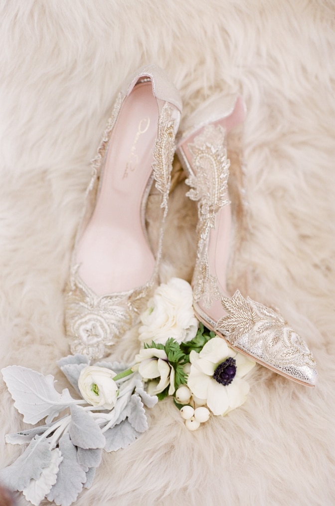 Gold lace Oscar de la Renta wedding shoes on white faux fur