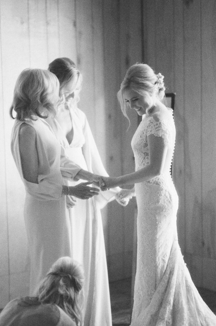 Bridal party dressing up the bride at Eaton Ranch