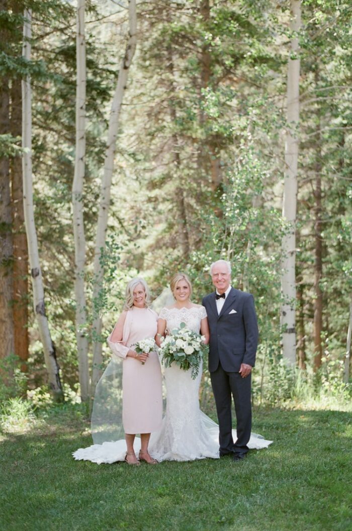 Bride and her parents taking family portraits at Eaton Ranch wedding