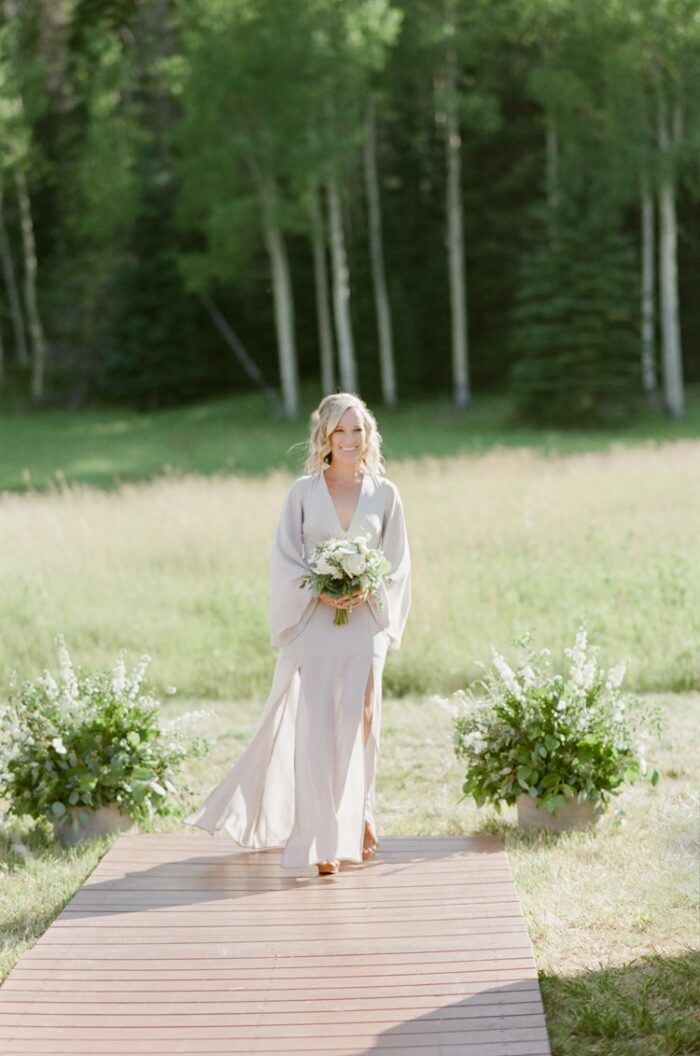 Bridesmaid walking down the aisle at Eaton Ranch wedding
