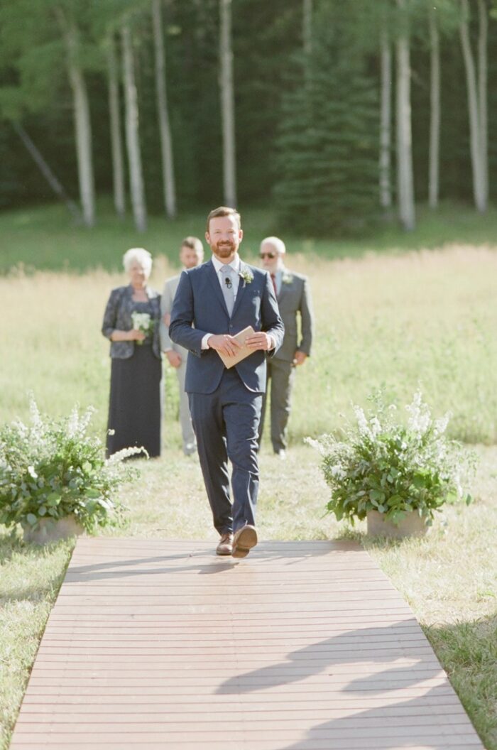 Officiant walking down the aisle during Eaton Ranch wedding
