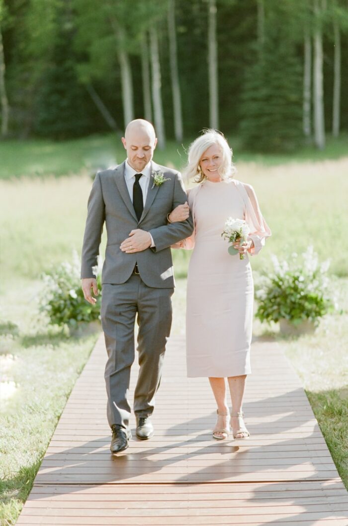 Mother of the bride and her son walking down the aisle at Vail wedding