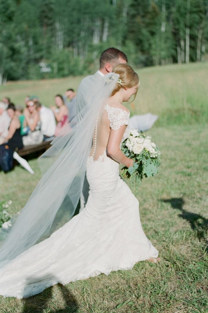 Bride and groom walking away from wedding aisle after saying 'I do'