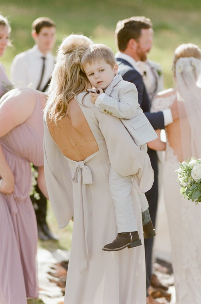 Maid of Honor carrying ring bearer at Eaton Ranch