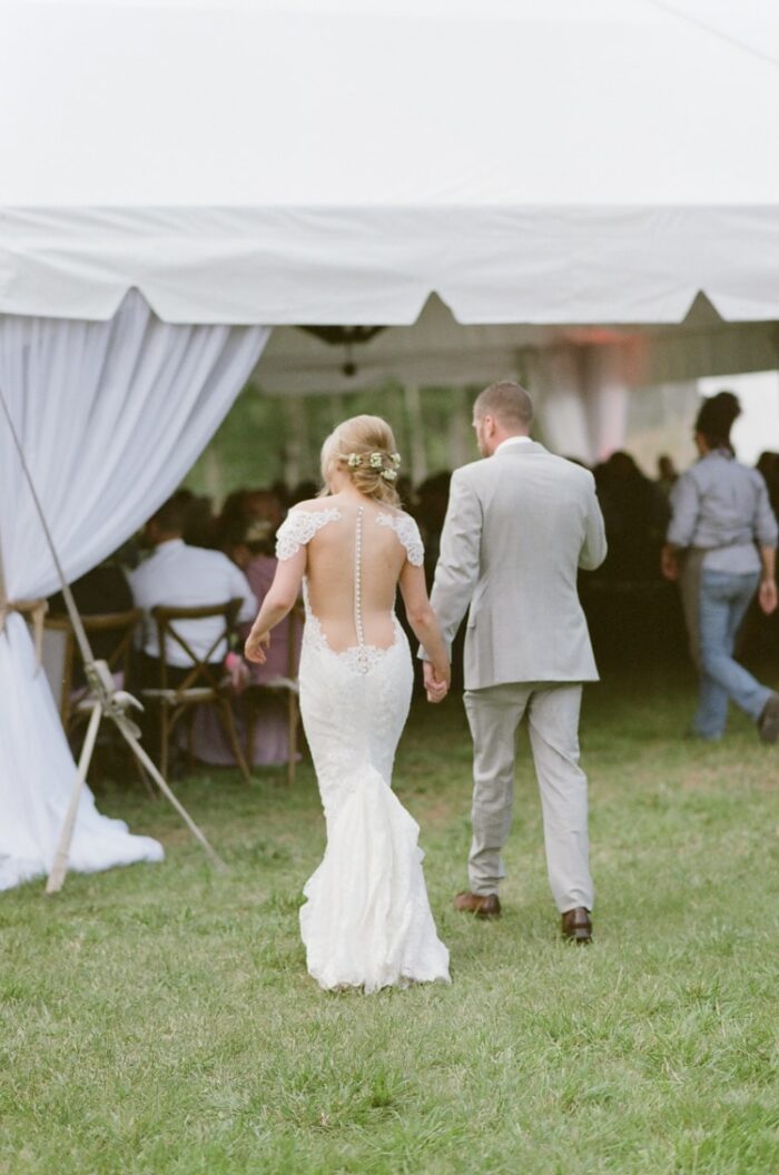 Bride and groom walking into their tent wedding reception at Eaton Ranch