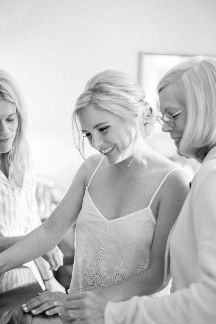 Bride with mother of bride reading a letter during getting ready session