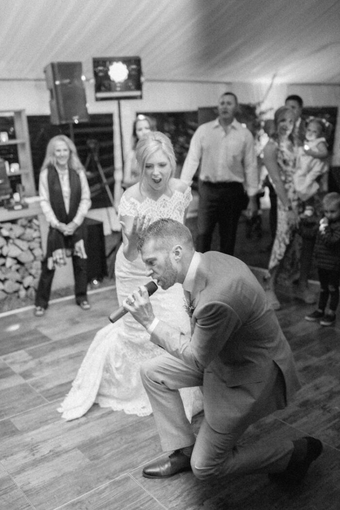 Groom singing for his bride during wedding reception in Colorado