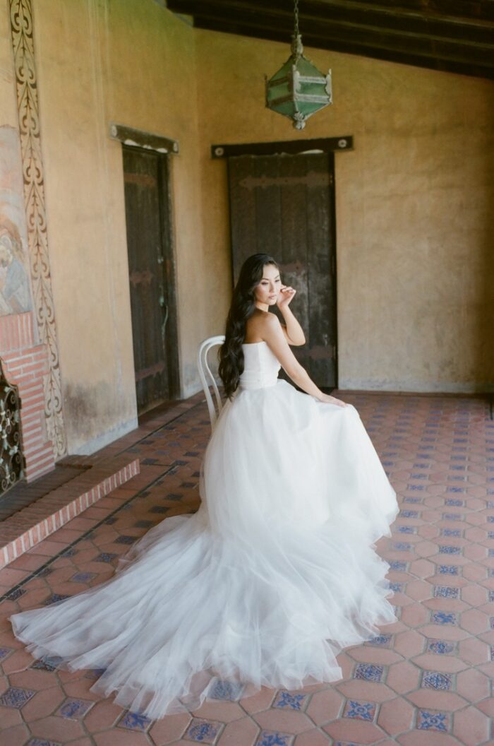 Bride putting her earrings on during her California wedding day