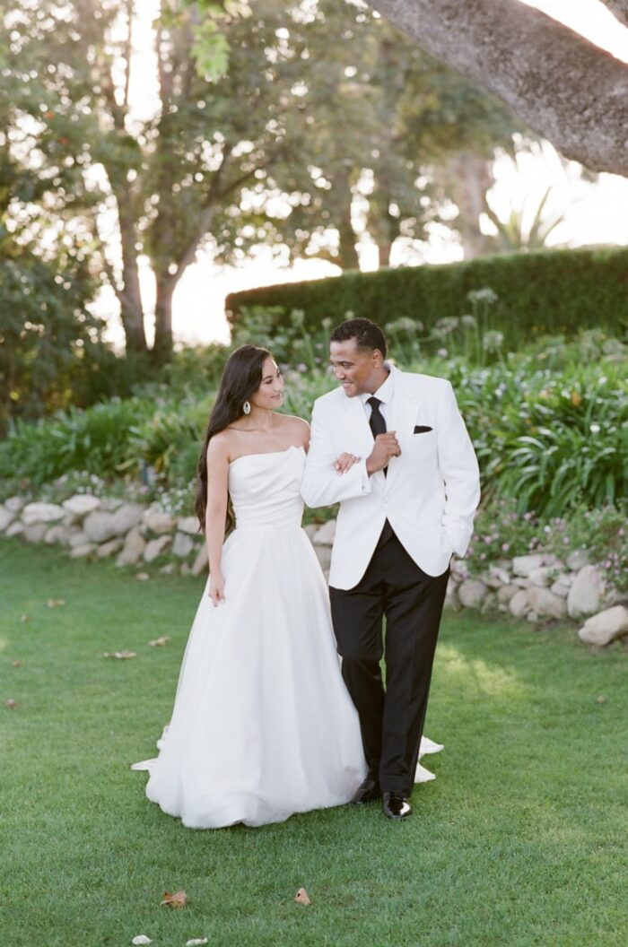 Bride and groom walking in the gardens of Adamson House on their California wedding day