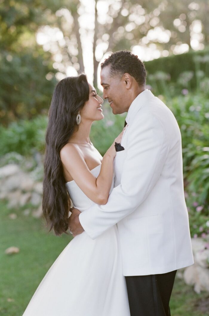 Bride and groom facing each other and embracing each other on their wedding in Malibu Beach