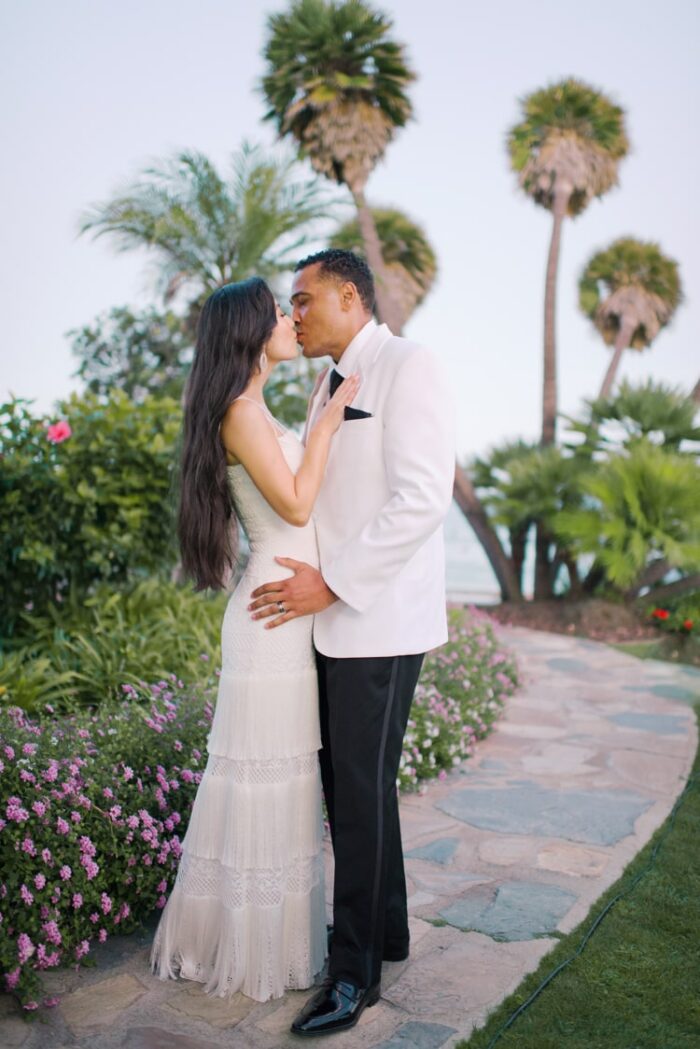 Bride and groom kissing each other during California sunset